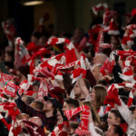 LONDON, ENGLAND - APRIL 01: Fans of Arsenal wave their scarves to show support for their team during the UEFA Women's Champions League 2025/26 Quarter-finals Second Leg match between Chelsea and Arsenal at Stamford Bridge on April 01, 2026 in London, England. (Photo by Warren Little/Getty Images)
