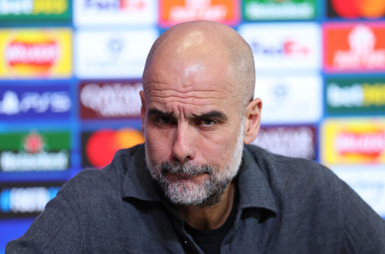 Pep Guardiola frowns at a press conference