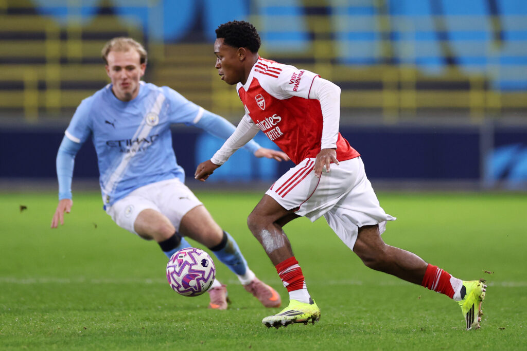 Brando Bailey-Joseph runs with the ball under pressure from Oliver Tevenan of Manchester City