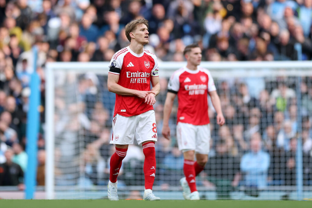 Martin Odegaard walks back to the halfway line against Manchester City