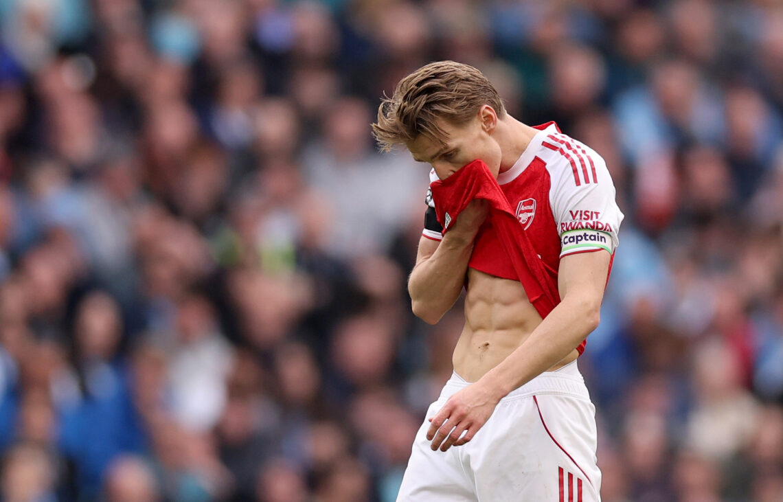 Martin Odegard uses his shirt to wipe his face, revealing his abs