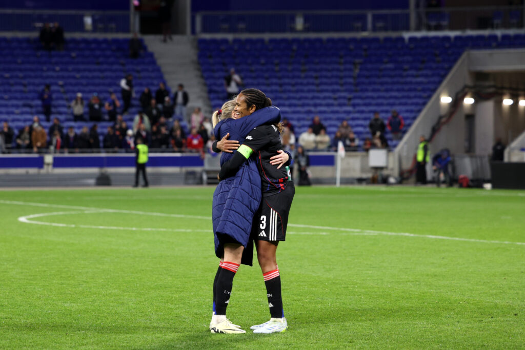 DECINES-CHARPIEU, FRANCE - APRIL 02: Wendie Renard of OL Lyonnes celebrates with team mate Ada Hegerberg following victory in the UEFA Women's Champions League 2025/26 Quarter-finals Second Leg match between OL Lyonnes and VfL Wolfsburg at OL Stadium on April 02, 2026 in Decines-Charpieu, France. (Photo by Pauline Figuet/Getty Images)