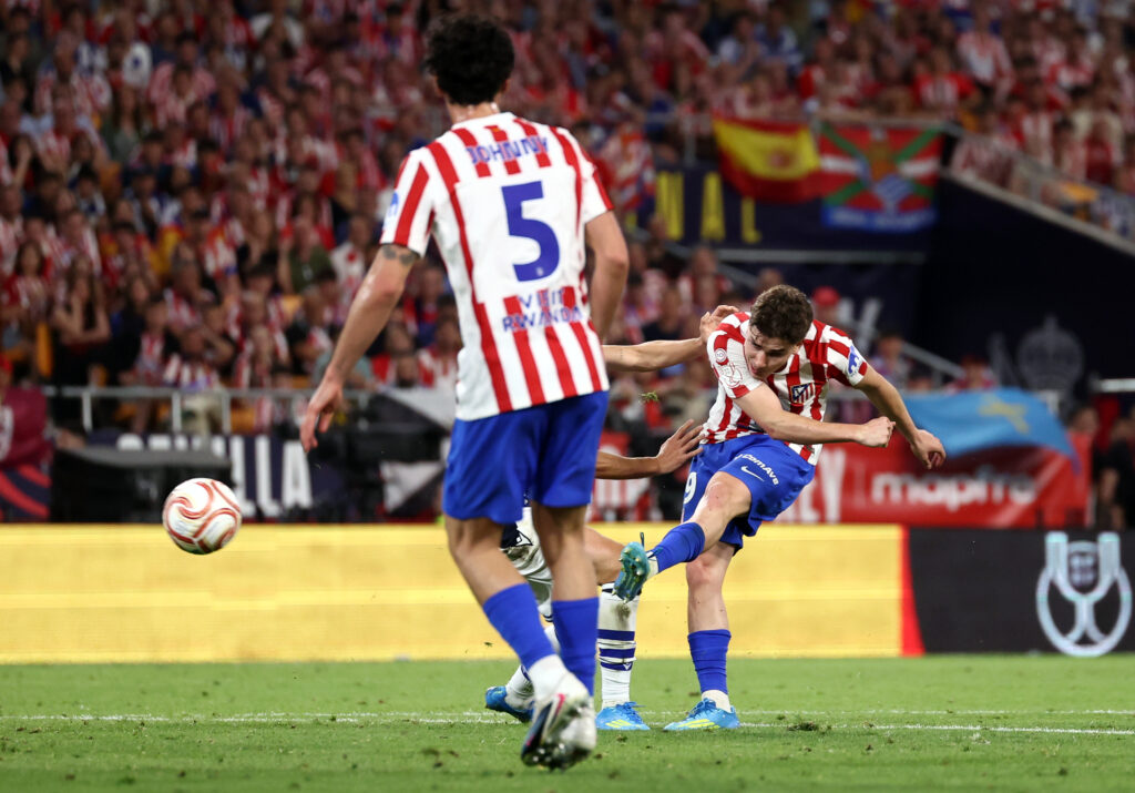 Julian Alvarez, in an Atletico Madrid kit, shoots at goal