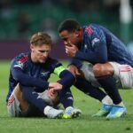 Martin Odegaard of Arsenal is spoken to by teammate Gabriel during the UEFA Champions League 2025/26 Quarter-Final First Leg match between Sporting Clube de Portugal and Arsenal FC at Estadio Jose Alvalade on April 07, 2026 in Lisbon, Portugal. (Photo by Clive Brunskill/Getty Images)