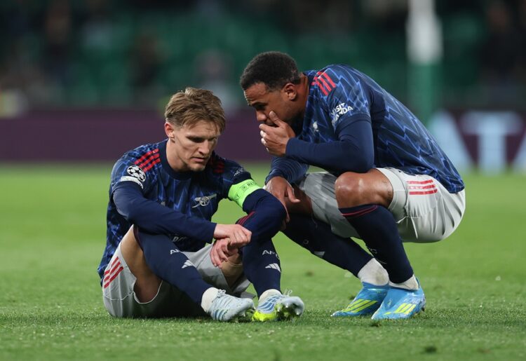 Martin Odegaard of Arsenal is spoken to by teammate Gabriel during the UEFA Champions League 2025/26 Quarter-Final First Leg match between Sporting...
