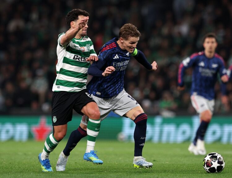 Martin Odegaard of Arsenal is challenged by Pedro Goncalves of Sporting Clube de Portugal during the UEFA Champions League 2025/26 Quarter-Final Fi...
