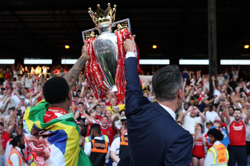 Gabriel of Arsenal, and Josh Kroenke, Co-Chair of Arsenal, lift the Premier League trophy, as Arsenal are crowned the Champions of the Premier League for the 2025/26 Season, after the Premier League match between Crystal Palace and Arsenal at Selhurst Park on May 24, 2026 in London, England.