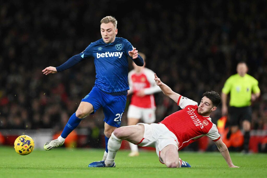 Jarrod Bowen of West Ham United is challenged by Declan Rice of Arsenal during the Premier League match between Arsenal FC and West Ham United at Emirates Stadium on December 28, 2023 in London, England.