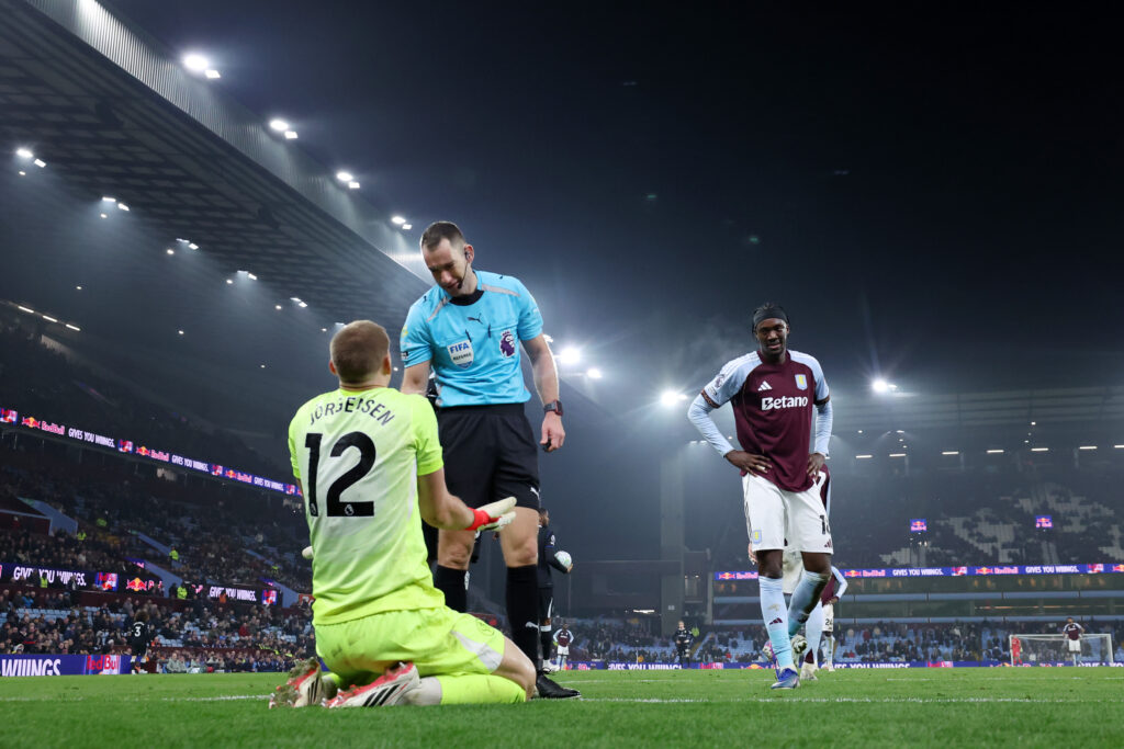 Filip Joergensen of Chelsea speaks with Referee Jarred Gillett after Tammy Abraham of Aston Villa took the ball off him during the Premier League match between Aston Villa and Chelsea at Villa Park on March 04, 2026 in Birmingham, England.