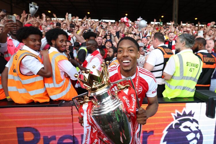 Myles Lewis-Skelly of Arsenal poses for a photograph the Premier League trophy as players of Arsenal celebrate, as they are crowned the Champions o...