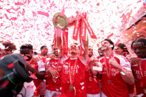 LONDON, ENGLAND - MAY 24: Martin Odegaard of Arsenal lifts the Premier League trophy as players of Arsenal celebrate, as they are crowned the Champions of the Premier League for the 2025/26 Season, after the Premier League match between Crystal Palace and Arsenal at Selhurst Park on May 24, 2026 in London, England. (Photo by Michael Regan/Getty Images For Premier League)