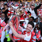 LONDON, ENGLAND - MAY 24: Declan Rice of Arsenal celebrates with the Premier League trophy as players of Arsenal celebrate, as they are crowned the Champions of the Premier League for the 2025/26 Season, after the Premier League match between Crystal Palace and Arsenal at Selhurst Park on May 24, 2026 in London, England. (Photo by Justin Setterfield/Getty Images)