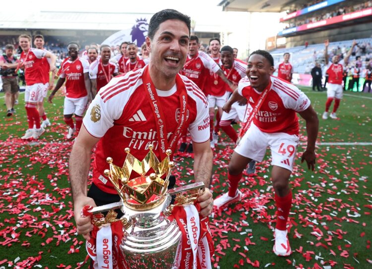 Mikel Arteta, Manager of Arsenal, celebrates with the Premier League trophy, as Arsenal are crowned the Champions of the Premier League for the 202...