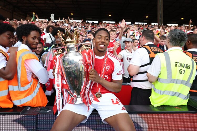 Myles Lewis-Skelly of Arsenal poses for a photograph the Premier League trophy as players of Arsenal celebrate, as they are crowned the Champions o...