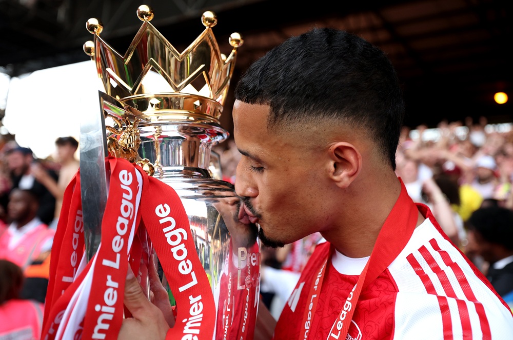 William Saliba of Arsenal kisses the Premier League trophy, as Arsenal are crowned the Champions of the Premier League for the 2025/26 Season, after the Premier League match between Crystal Palace and Arsenal at Selhurst Park on May 24, 2026 in London, England. (Photo by Michael Regan/Getty Images For Premier League)