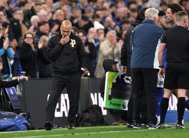 Manchester City Head Coach Pep Guardiola reacts on the sidelines during the Premier League match between Everton and Manchester City at Hill Dickin...