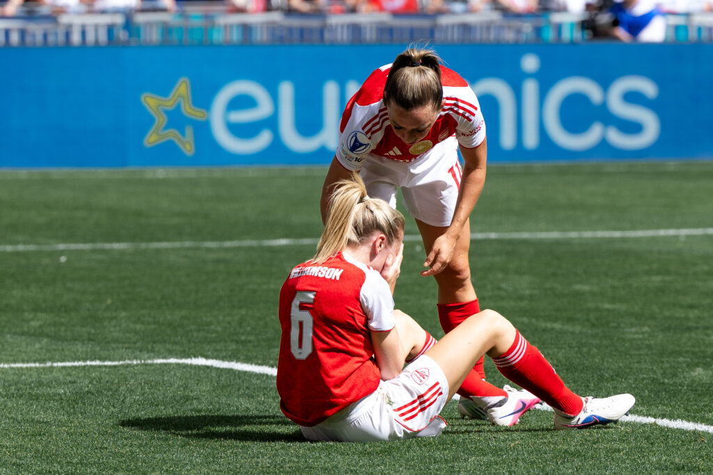 McCabe Katie of Arsenal FC helping Williamson Leah of Arsenal FC during the UEFA Women's Champions League 2025/26 Semi-Final Second Leg match between OL Lyonnes and Arsenal FC at OL Stadium on May 2, 2026 in Decines-Charpieu, France.