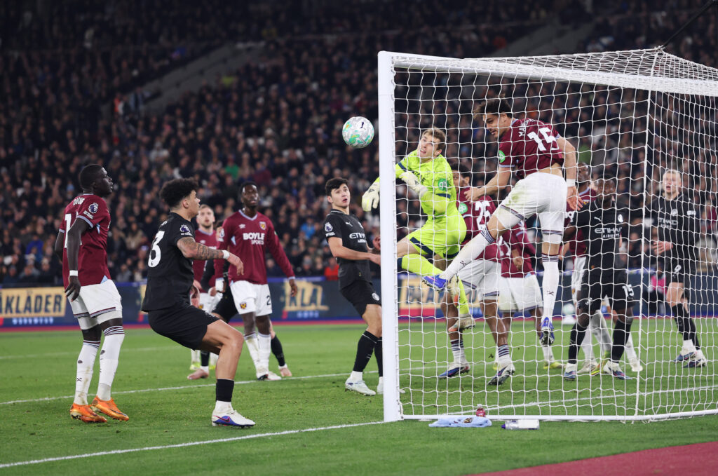 Konstantinos Mavropanos of West Ham United clears the ball on the line, as Mads Hermansen of West Ham United attempts to make a save during the Premier League match between West Ham United and Manchester City at London Stadium on March 14, 2026