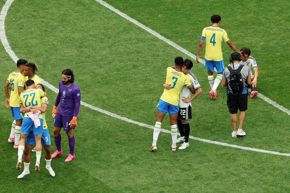 Gabriel Magalhaes #3 of Brazil embraces Takehiro Tomiyasu #22 of Japan after the FIFA World Cup 2026 Round Of 32 match between Brazil and Japan at Houston Stadium on June 29, 2026 in Houston, Texas. (Photo by Molly Darlington/Getty Images)