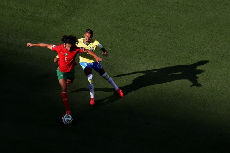 Ayyoub Bouaddi #6 of Morocco is challenged by Raphinha #11 of Brazil during the FIFA World Cup 2026 Group C match between Brazil and Morocco at New...