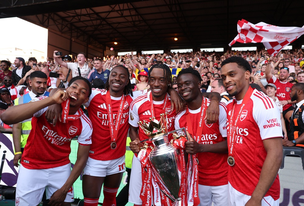 Myles Lewis-Skelly, Eberechi Eze, Noni Madueke, Bukayo Saka and Jurrien Timber of Arsenal pose for a photograph the Premier League trophy as players of Arsenal celebrate, as they are crowned the Champions of the Premier League for the 2025/26 Season, after the Premier League match between Crystal Palace and Arsenal at Selhurst Park on May 24, 2026 in London, England. (Photo by Michael Regan/Getty Images For Premier League)