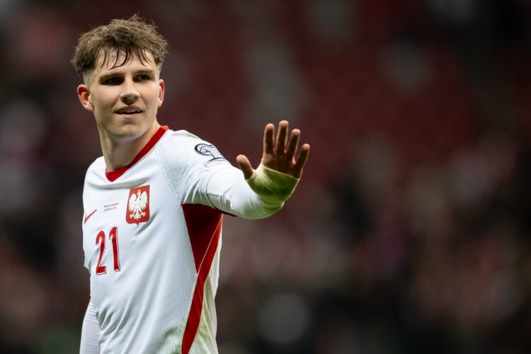 Oskar Pietuszewski of Poland celebrates after the team's victory during the FIFA World Cup 2026 European Qualifiers KO play-offs match between Pola...
