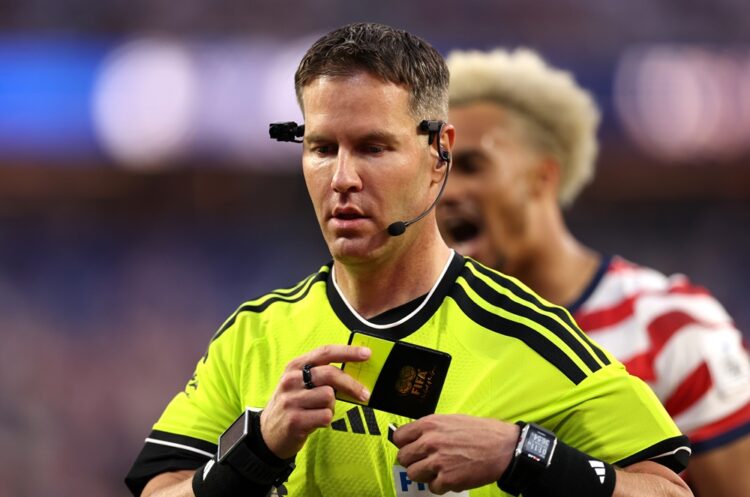 Referee Danny Makkelie looks on as a VAR check is underway for 'mistaken identify' involving an tackle between Miguel Almiron #10 of Paraguay and T...