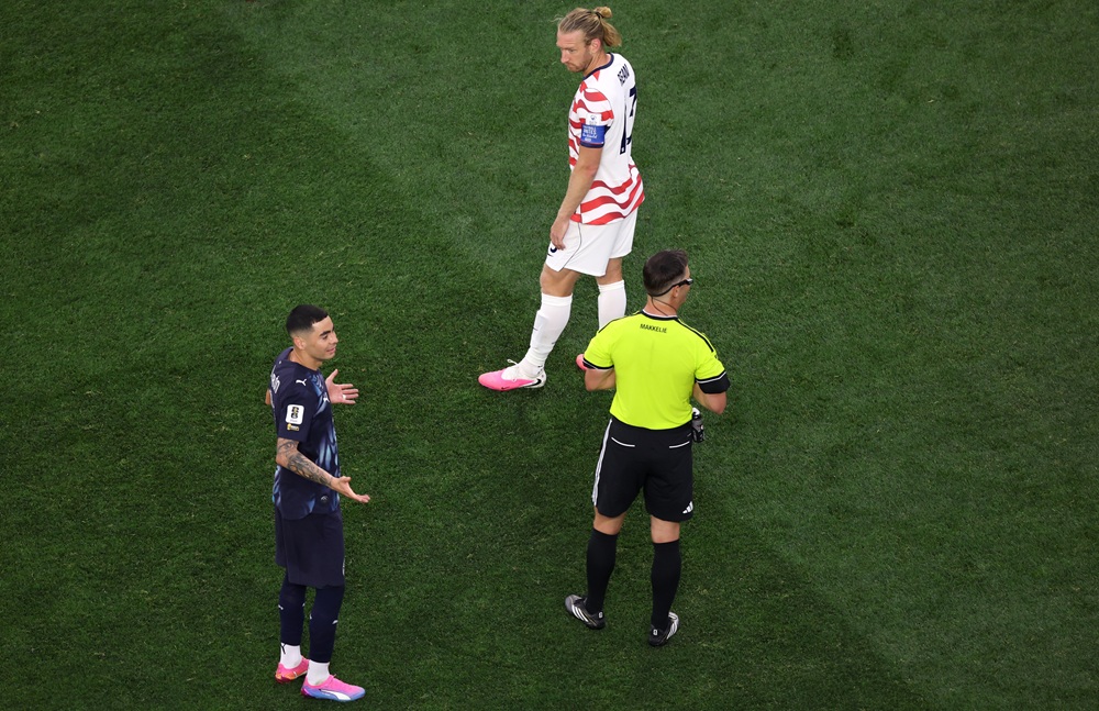 Referee Danny Makkelie speaks to the Miguel Almiron #10 of Paraguay and Tim Ream #13 of the United States as VAR check is underway for 'mistaken identify' involving an tackle between the two players during the FIFA World Cup 2026 Group D match between USA and Paraguay at Los Angeles Stadium on June 12, 2026 in Los Angeles, California. (Photo by Harry How/Getty Images)