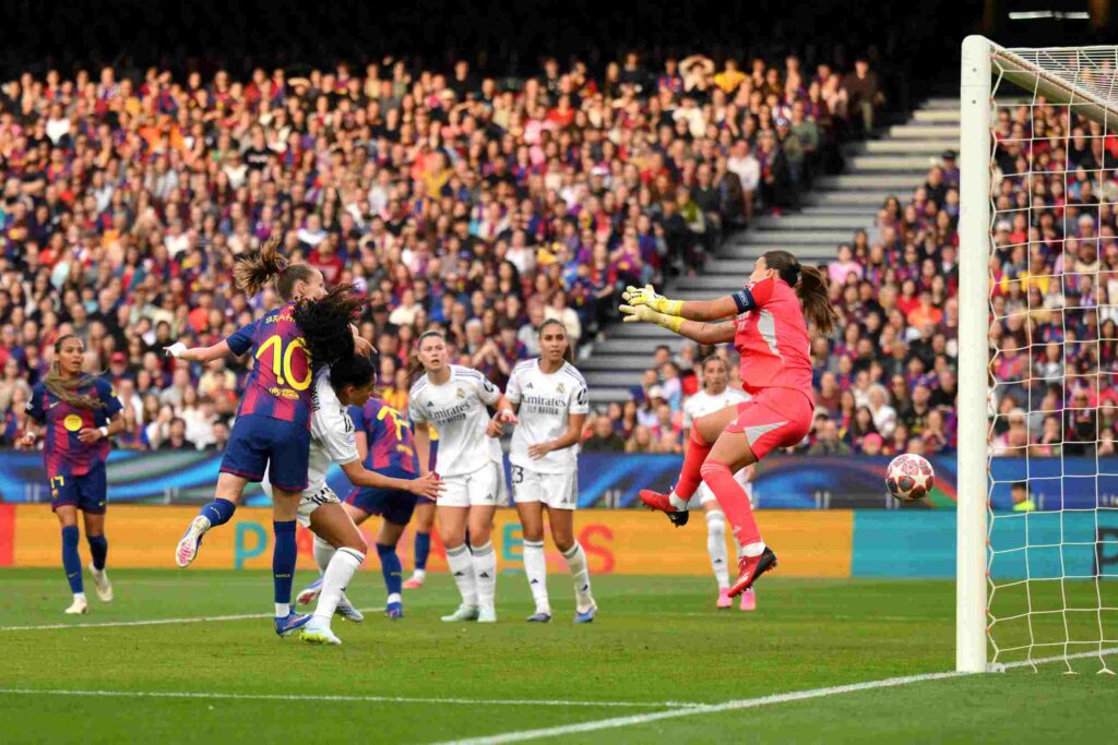 Caroline Graham Hansen of FC Barcelona scores her team's second goal against Misa Rodriguez of Real Madrid