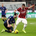 Ismael Bennacer of AC Milan is put under pressure by Hakan Calhanoglu of FC Internazionale during the Serie A match between AC Milan and FC Internazionale at Stadio Giuseppe Meazza on February 02, 2025 in Milan, Italy. (Photo by Marco Luzzani/Getty Images)