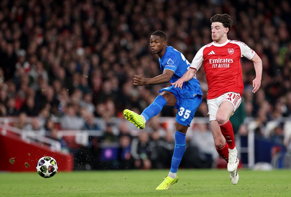 Christian Kofane of Bayer 04 Leverkusen shoots whilst under pressure from Declan Rice of Arsenal during the UEFA Champions League 2025/26 Round of 16 Second Leg match between Arsenal FC and Bayer 04 Leverkusen at Arsenal Stadium on March 17, 2026 in London, England. (Photo by Warren Little/Getty Images)