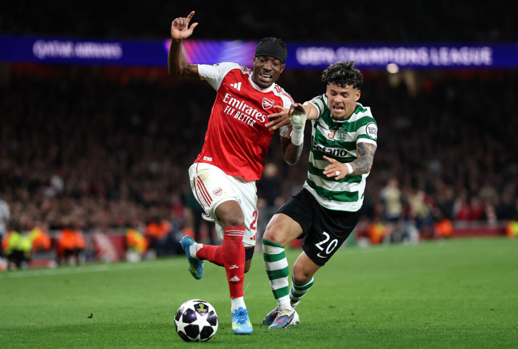 LONDON, ENGLAND - APRIL 15: Noni Madueke of Arsenal runs with the ball whilst under pressure from Maximiliano Araujo of Sporting Clube de Portugal during the UEFA Champions League 2025/26 Quarter-Final Second Leg match between Arsenal FC and Sporting Clube de Portugal at Arsenal Stadium on April 15, 2026 in London, England. (Photo by Justin Setterfield/Getty Images)