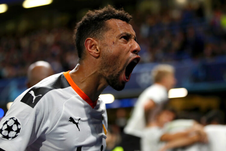 Francis Coquelin celebrates as Rodrigo Moreno of Valencia scores his team's first goal during the UEFA Champions League group H match between Chels...