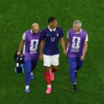 William Saliba #17 of France walks off the pitch with medical staff after sustaining an injury during the FIFA World Cup 2026 Semi Final match between France and Spain at Dallas Stadium on July 14, 2026 in Arlington, Texas. (Photo by Kevin C. Cox/Getty Images)