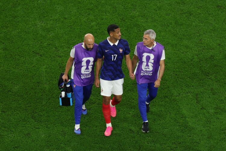 William Saliba #17 of France walks off the pitch with medical staff after sustaining an injury during the FIFA World Cup 2026 Semi Final match betw...