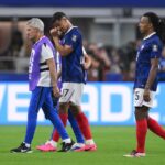 William Saliba #17 of France walks off the pitch with medical staff after sustaining an injury during the FIFA World Cup 2026 Semi Final match between France and Spain at Dallas Stadium on July 14, 2026 in Arlington, Texas. (Photo by David Ramos/Getty Images)