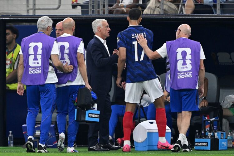 Didier Deschamps, Head Coach of France, checks on William Saliba #17 after he comes off with an injury during the FIFA World Cup 2026 Semi Final ma...