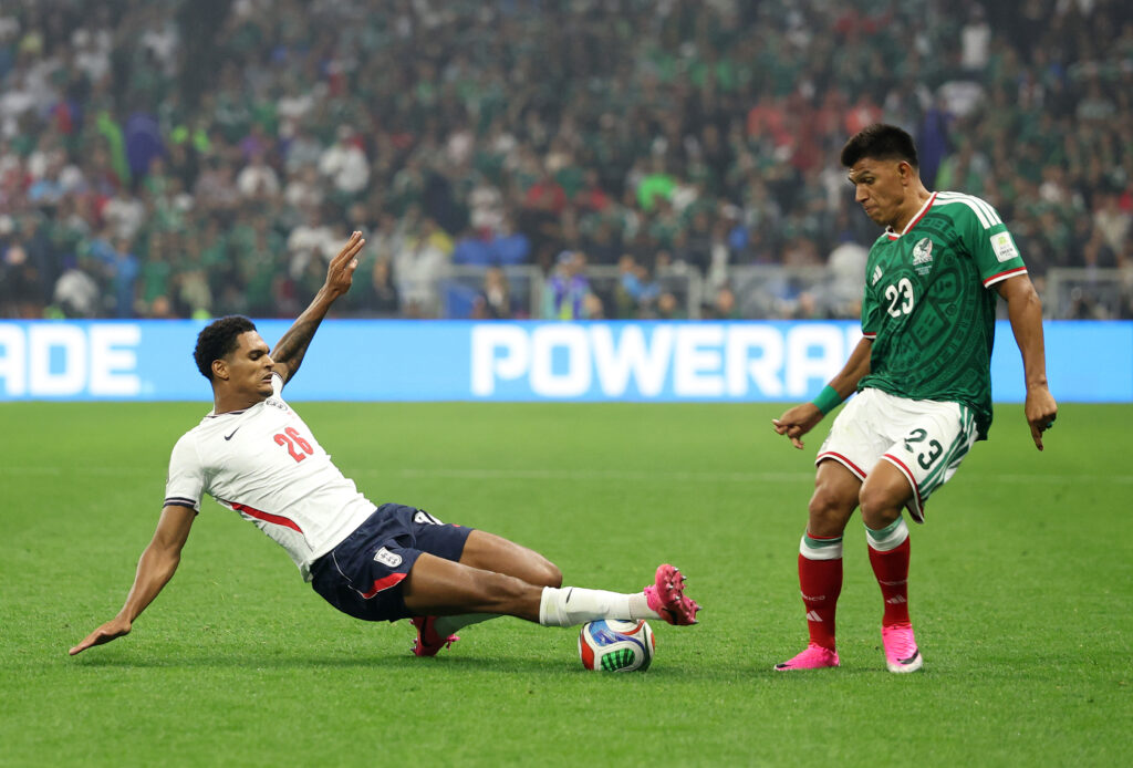 Jesus Gallardo #23 of Mexico is tackled by Jarell Quansah #26 of England during the FIFA World Cup 2026 Round of 16 match between Mexico and England at Mexico City Stadium