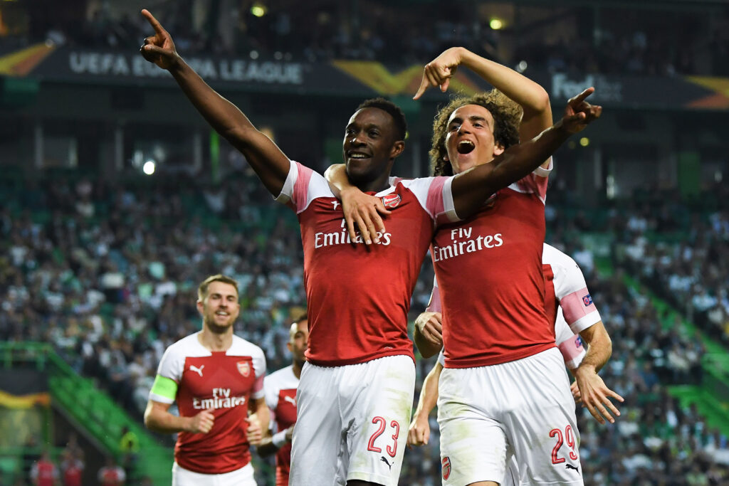 Danny Welbeck (L) of Arsenal FC celebrates with his team mate Matteo Guedouzi after scoring his team's first goal during the UEFA Europa League Group E match between Sporting CP and Arsenal