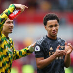 BRENTFORD, ENGLAND - SEPTEMBER 18: Ethan Nwaneri (R) of Arsenal applauds the fans next to Gabriel Martinelli following the Premier League match between Brentford FC and Arsenal FC at Brentford Community Stadium on September 18, 2022 in Brentford, England. (Photo by Alex Pantling/Getty Images)