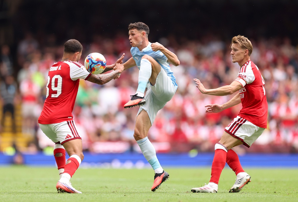 Arsenal summer signings Bruno & Tzolis praised by new teammates 3 Phil Foden of Manchester City is challenged by Bruno Guimaraes and Martin Odegaard of Arsenal during the 2026 FA Community Shield match between Arsenal and Manchester City at Principality Stadium on August 16, 2026 in Cardiff, Wales. (Photo by Carl Recine/Getty Images)