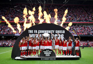 CARDIFF, WALES - AUGUST 16: Martin Odegaard of Arsenal lifts the FA Community Shield trophy with teammates after the 2026 FA Community Shield match between Arsenal and Manchester City at Principality Stadium on August 16, 2026 in Cardiff, Wales. (Photo by Shaun Botterill/Getty Images)