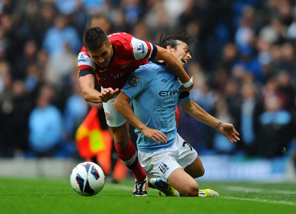 Ex-Arsenal fan favourite announces retirement at 34 5 MANCHESTER, ENGLAND - SEPTEMBER 23: Carl Jenkinson of Arsenal clashes with David Silva of Manchester City during the Barclays Premier League match between Manchester City and Arsenal at Etihad Stadium on September 23, 2012 in Manchester, England. (Photo by Laurence Griffiths/Getty Images)
