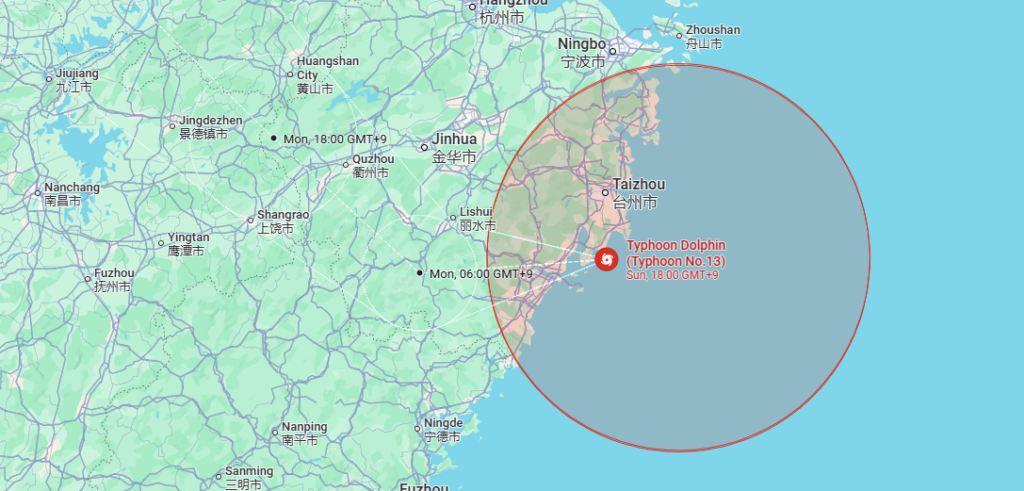 Weather map of eastern China showing Typhoon Dolphin offshore east of Zhejiang, with its projected track curving north toward the coast near Taizhou and Ningbo. A large red forecast cone covers coastal Zhejiang and the East China Sea, with timestamps for Sunday evening, Monday morning and Monday evening.