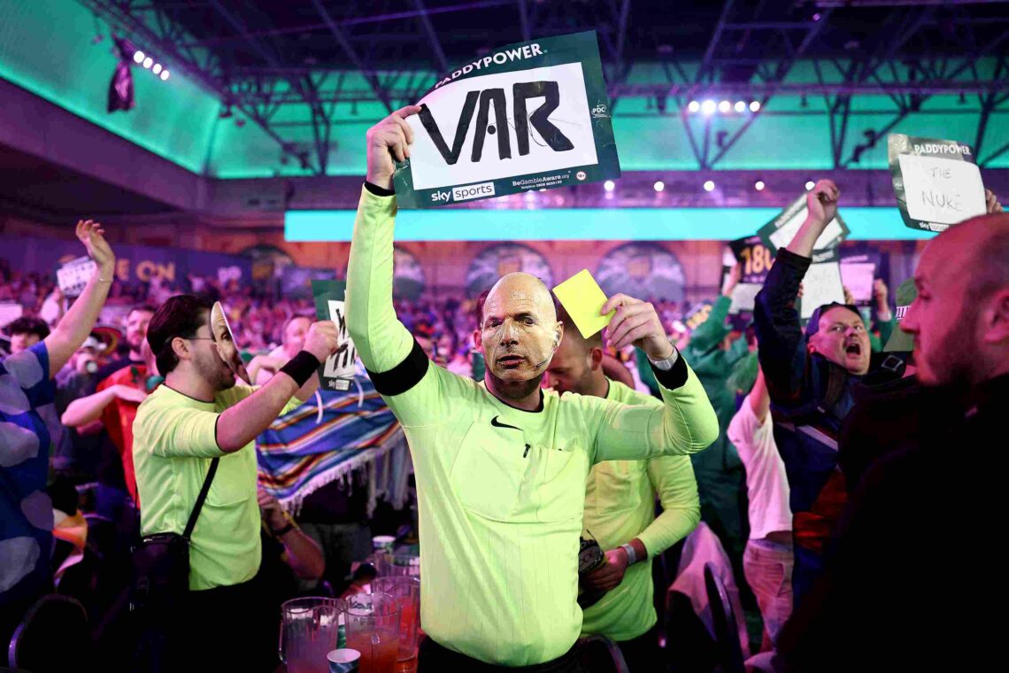 LONDON, ENGLAND - DECEMBER 27: A fan dressed as a Referee, wearing a mask of former Referee Howard Webb whilst holding a sign which reads "VAR" and...