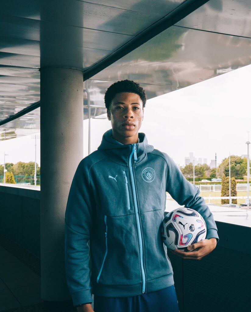 Mishel Nduka signing for Manchester City (Photo via Nduka on Instagram)