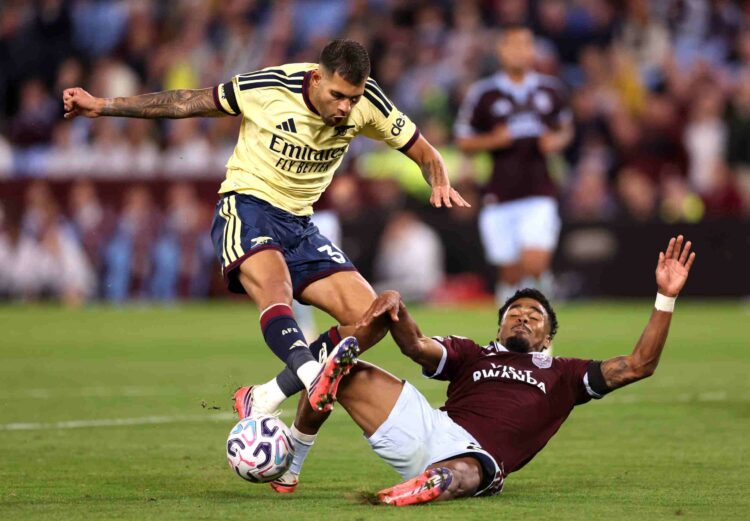Bruno Guimaraes of Arsenal is challenged by Ian Maatsen of Aston Villa during the Premier League 2026/27 match between Aston Villa FC and Arsenal F...