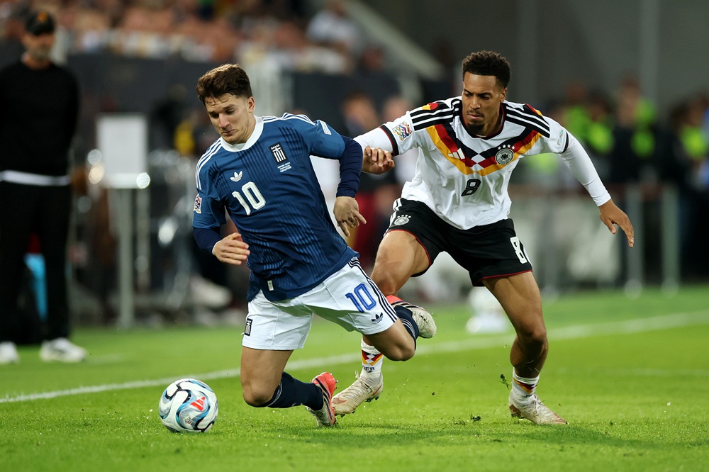 Christos Tzolis of Greece falls after a challenge from Felix Nmecha of Germany during the UEFA Nations League 2026/27 group phase match between Germany and Greece at WWK Arena on September 27, 2026 in Augsburg, Germany. (Photo by Alex Grimm/Getty Images)