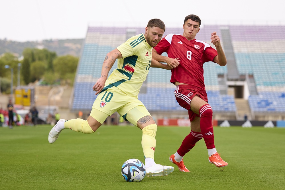 Wes Burns of Wales is challenged by James Robert Scanlon of Gibraltar during the international friendly match between Gibraltar and Wales at Estadio Algarve on June 06, 2024 in Faro, Portugal. (Photo by Fran Santiago/Getty Images)