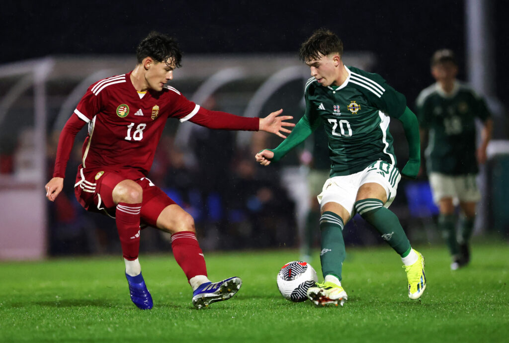 BURTON UPON TRENT, ENGLAND - MARCH 26: Ceadach O'Neill of Northern Ireland is challenged by Adam Decsy of Hungary during the Under-17 EURO Elite Round match between Hungary and Northern Ireland at St George's Park on March 26, 2024 in Burton upon Trent, England. (Photo by Cameron Smith/Getty Images )